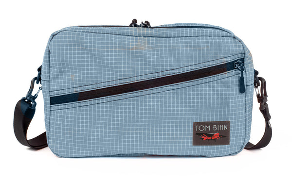 A Packing Cube Shoulder Bag in Tidal (light bluish-grey with white grid) 200 Halcyon with a 1-inch shoulder strap attached
